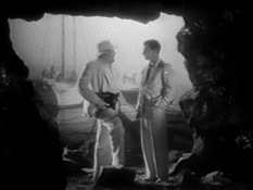 Moreau and Parker in the mouth of a cave near the dock